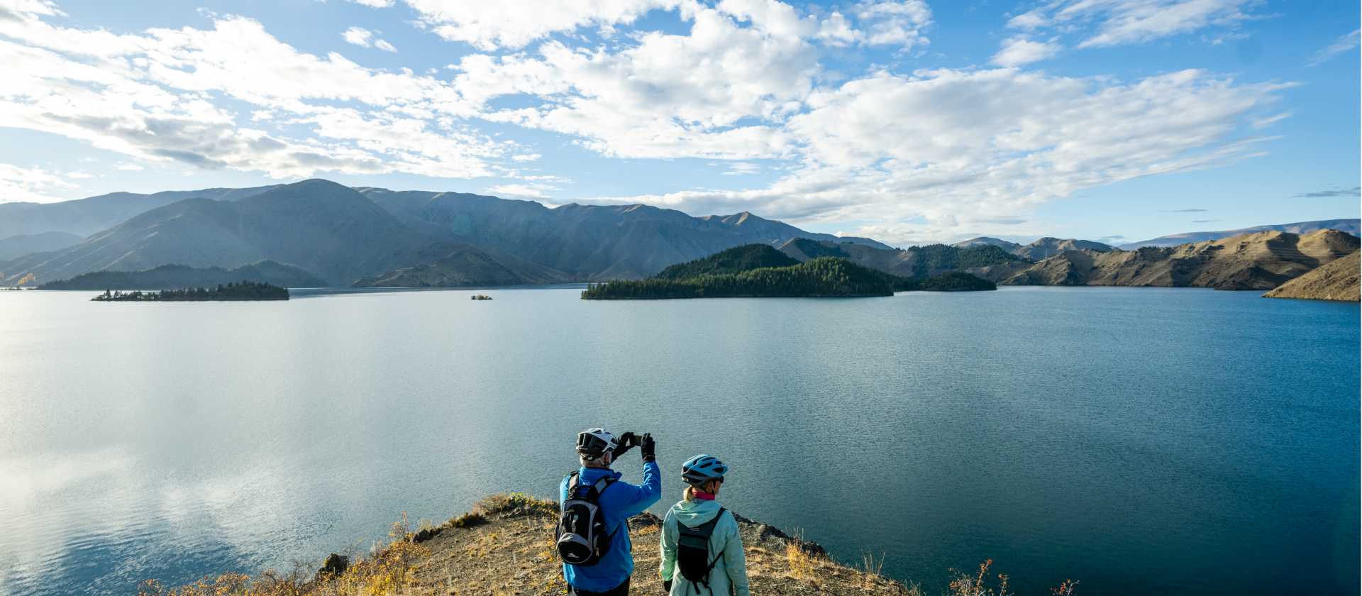 Cycling along the beautiful Benmore Dam on the Alps to Ocean. | Clare Toia-Bailey