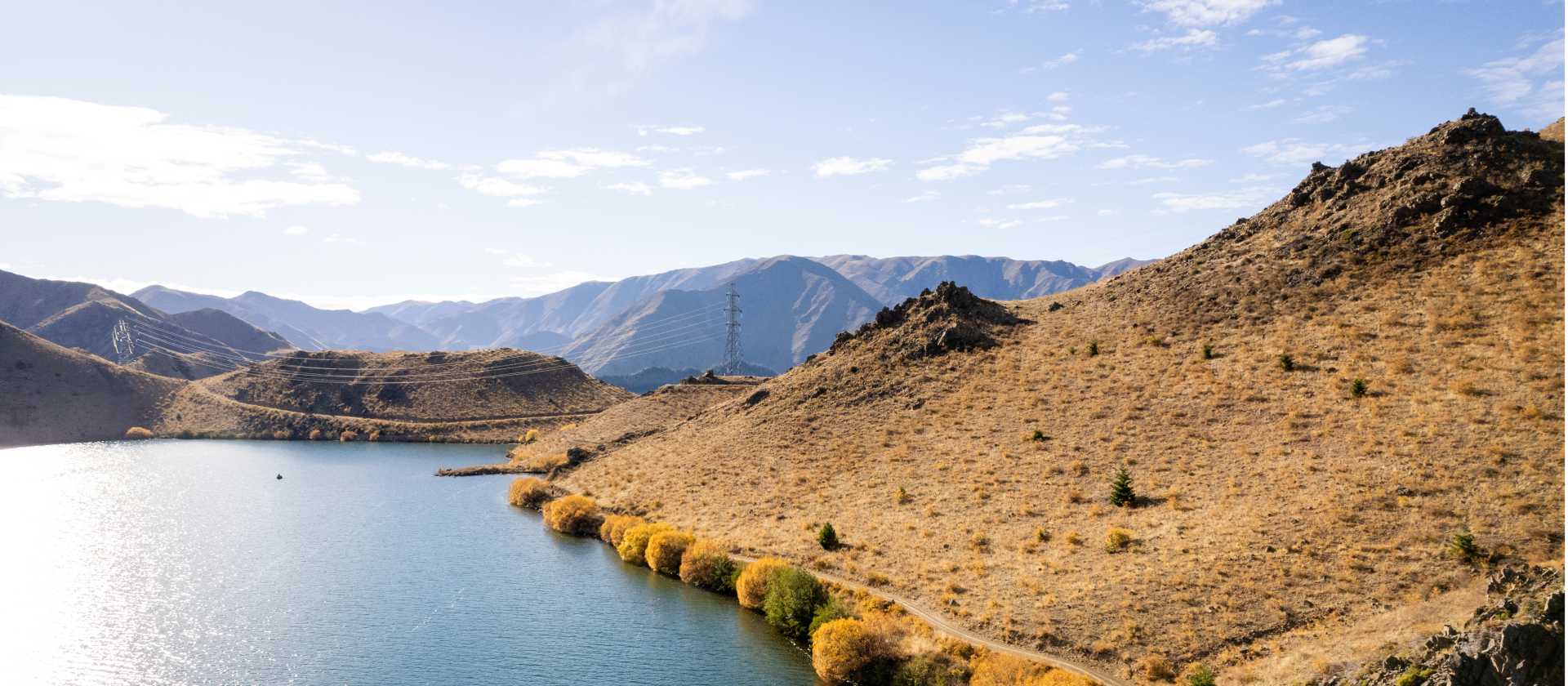 Cycling along the beautiful Benmore Dam on the Alps to Ocean. | Clare Toia-Bailey