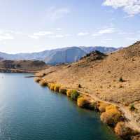 Cycling along the beautiful Benmore Dam on the Alps to Ocean. | Clare Toia-Bailey