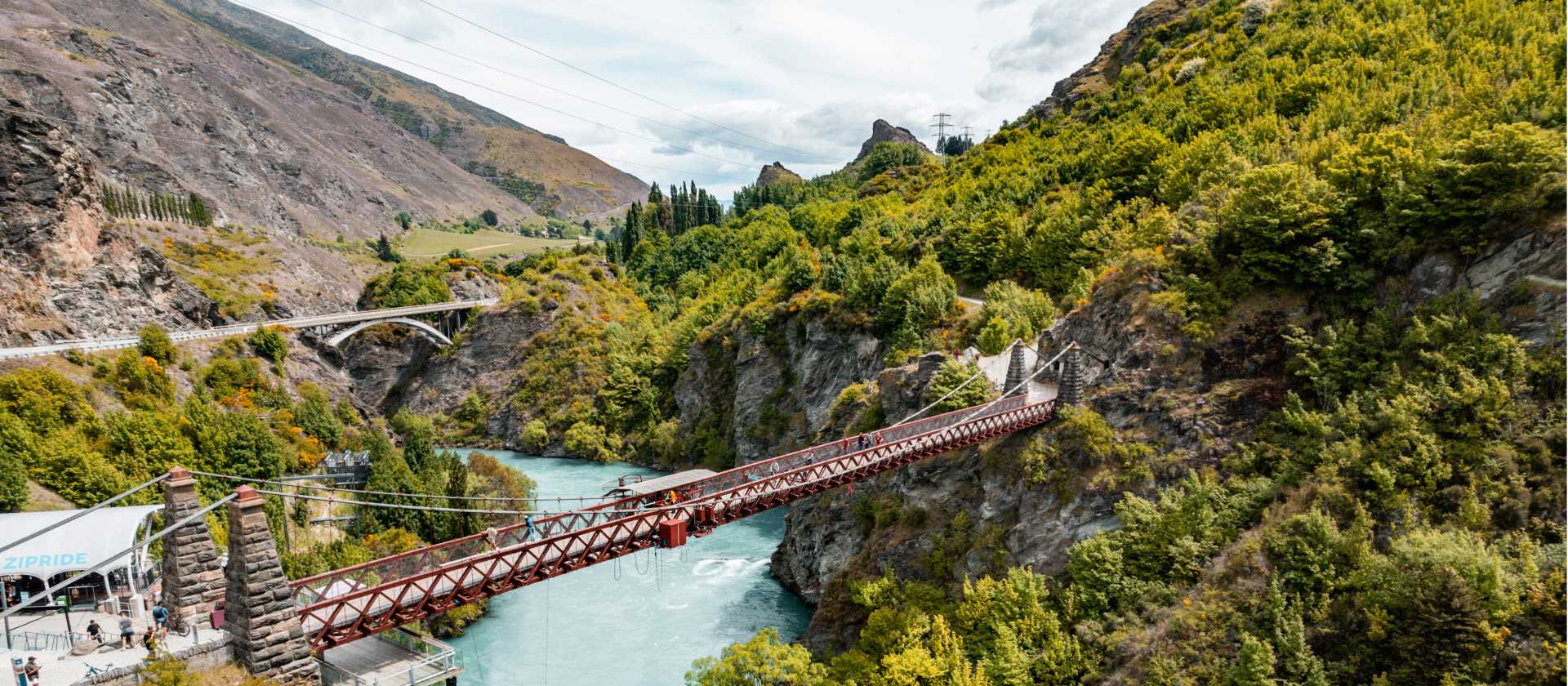 Cycling across the Kawarau Gorge Suspension Bridge on the way to the Gibbston Valley | Miles Holden