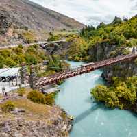 Cycling across the Kawarau Gorge Suspension Bridge on the way to the Gibbston Valley | Miles Holden