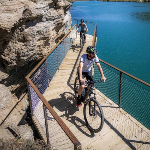 Cyclists riding by Lake Dunstan