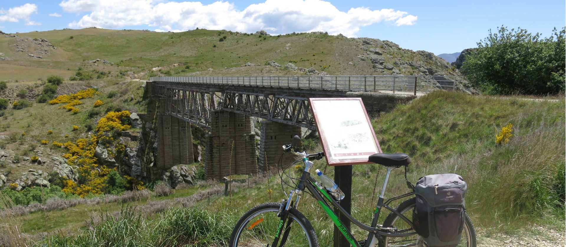 Cycle over the flowing waters of the Manuherikia on longest bridge (110m) on the Central Otago Rail Trail | Trail Journeys