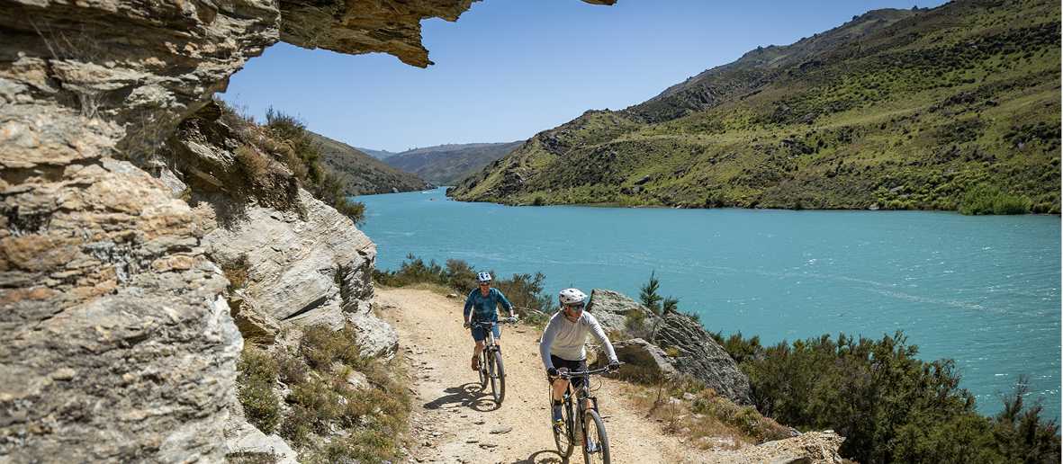 Cyclists ride south towards Roxburgh on Roxburgh Gorge Trail, with the Roxburgh Gorge and Shingle Creek in the background | Geoff Marks