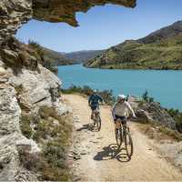 Cyclists ride south towards Roxburgh on Roxburgh Gorge Trail, with the Roxburgh Gorge and Shingle Creek in the background | Geoff Marks