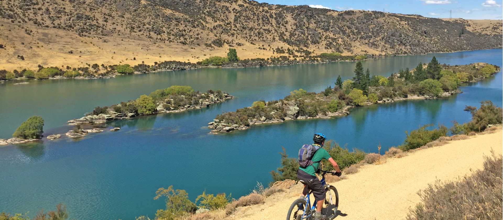 Cycling high above Lake Roxburgh | bennettandslater.co.nz